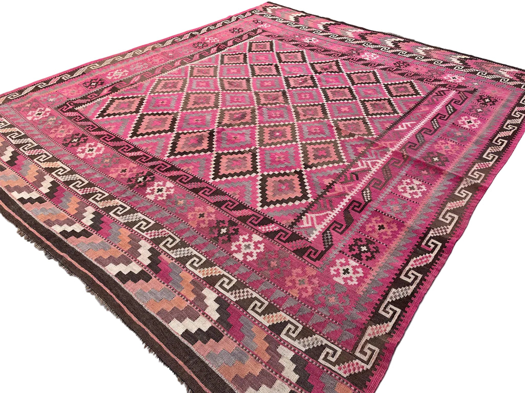 Close-up view of geometric tribal designs woven into an authentic Afghan Kilim wool rug