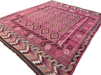 Close-up view of geometric tribal designs woven into an authentic Afghan Kilim wool rug