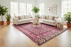Vintage Afghan Kilim rug displayed from an angled perspective showcasing blush pink and brown tribal patterns