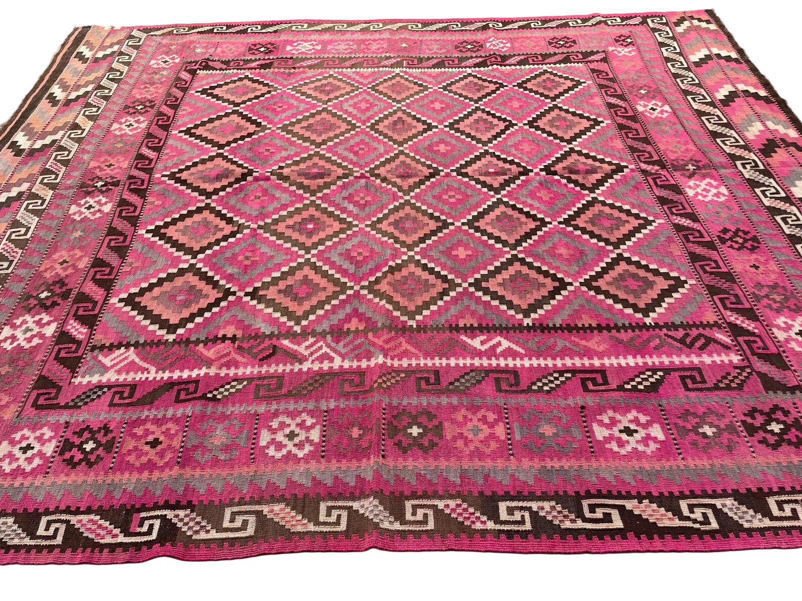 Vintage wool Afghan carpet with detailed tribal motifs and a soft rose-toned colour palette
