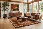 Rust orange and brown Afghan Kilim rug styled in a luxury mid-century modern living room with cognac leather sofa and walnut furniture.